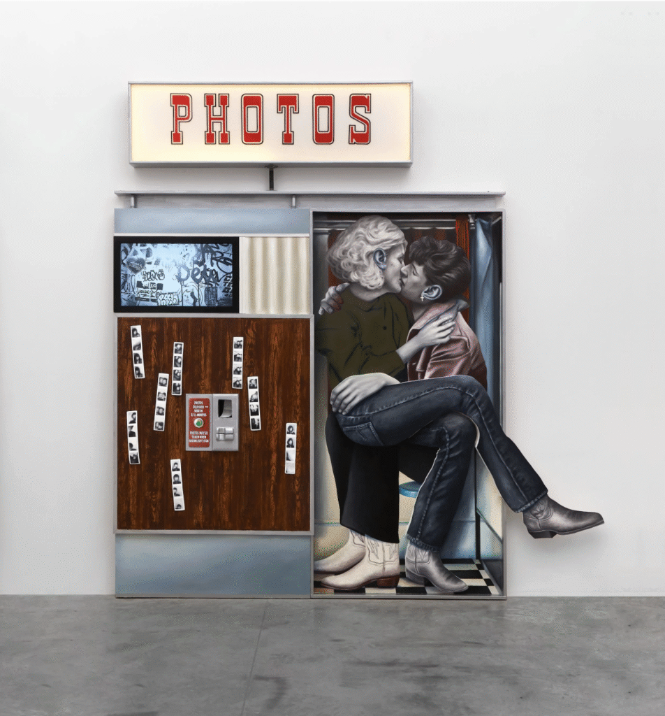 People sitting in a kissing booth cut out of wood